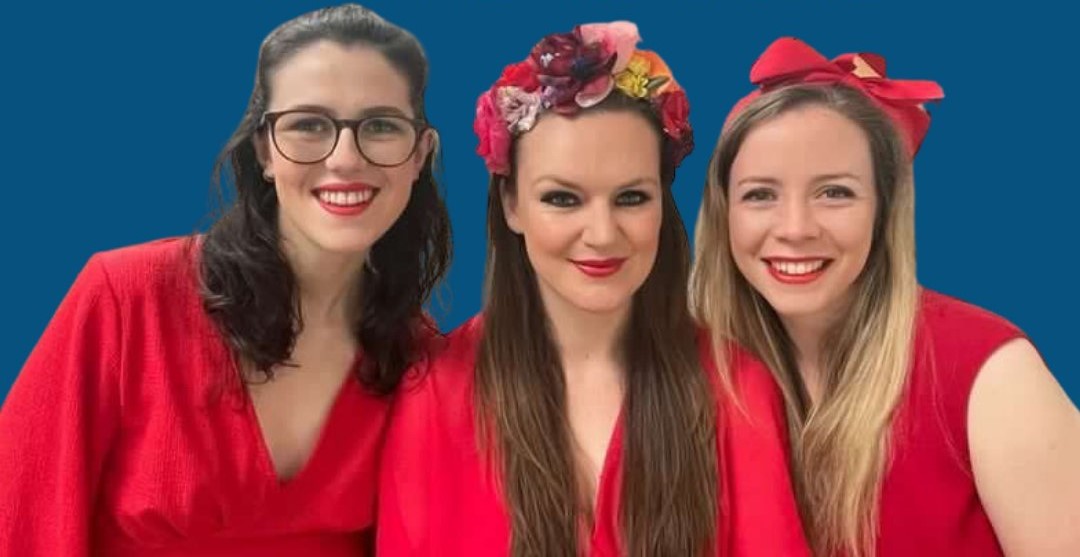 Group photo of CALYPSO MOON, Eleanor Dattani, Lydia Glanville and Amy Coates, who are all wearing red dresses