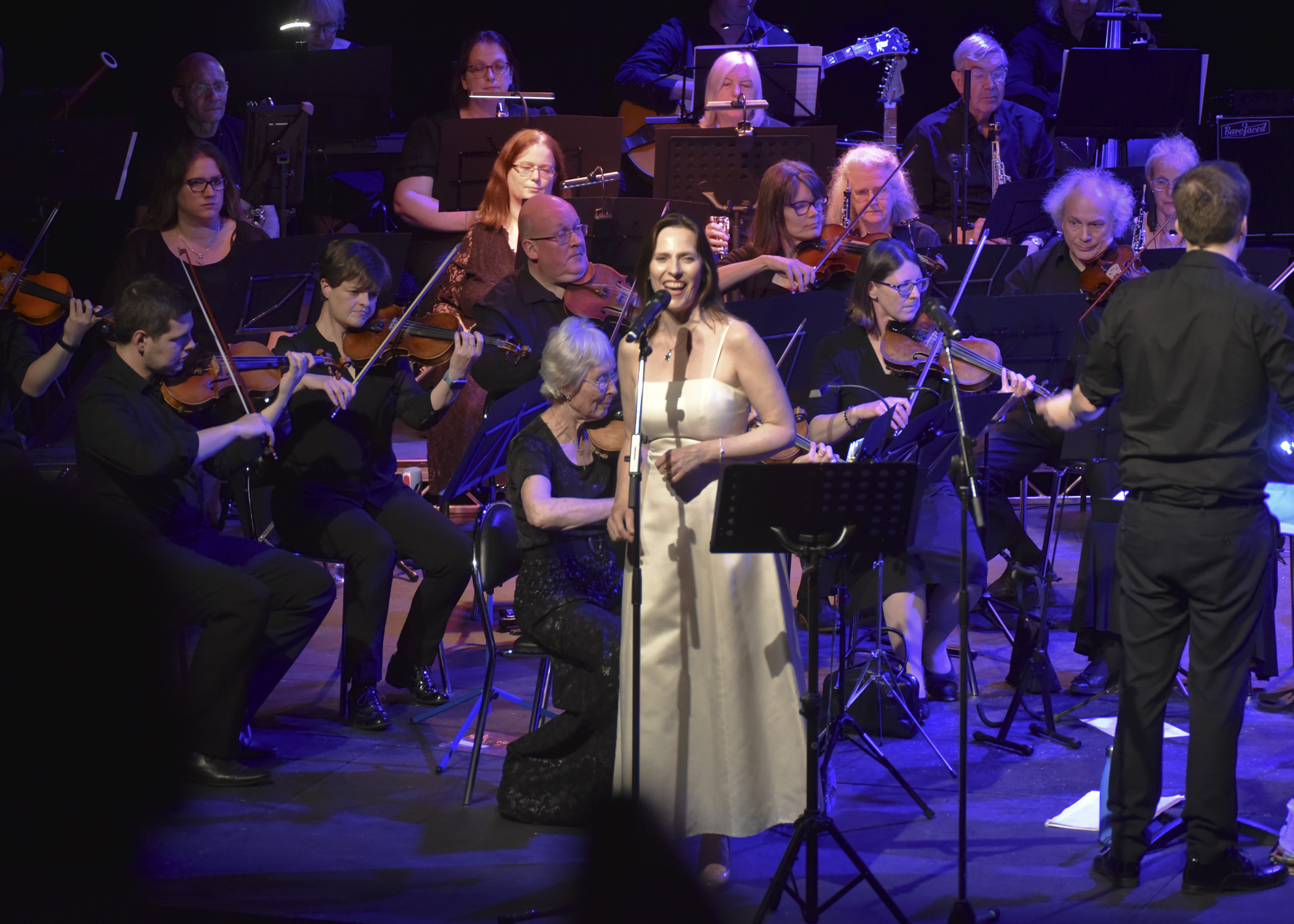 Soloist singing in front of the Midland Concert Orchestra