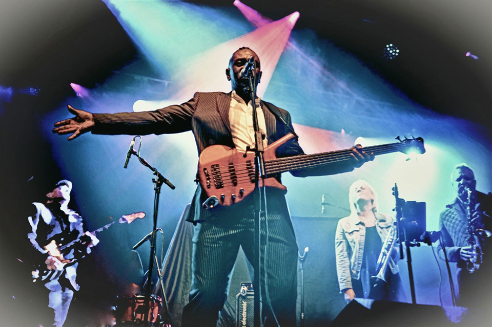 Promotional image of Cantaloop on stage playing their instruments