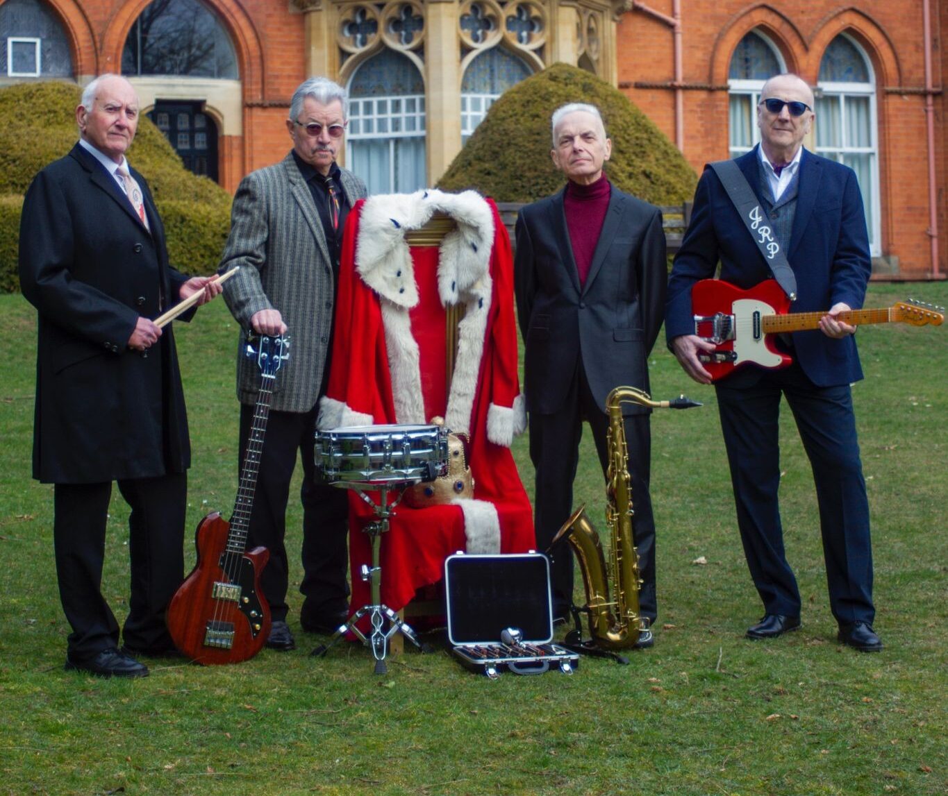 Lined up, Vee Jay King and his Dukes, outside a red brick building, standing on a lawn: John Roy Potter Ricky Cool Chris Lomas Howard Smith