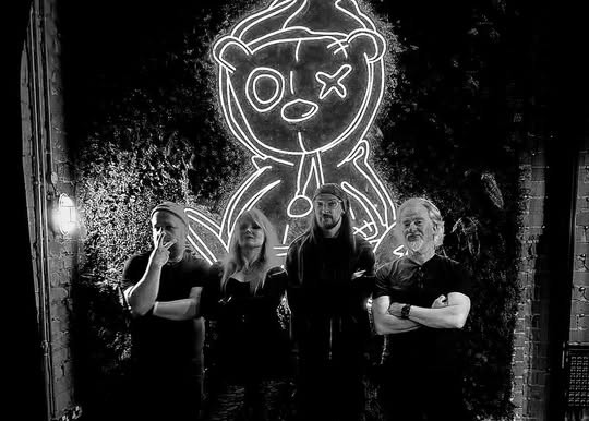 Black & White group photo of The Beautiful Darkness, an emerging rock band that blends goth and grunge influences into a unique sound.