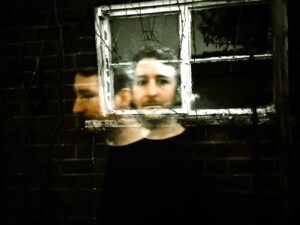 Ghostly image of Glen Bartley in front of a window 