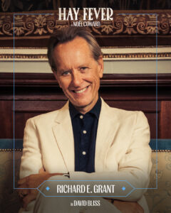 Promotional poster for Hay Fever by Noël Coward featuring Richard E. Grant; portrait of a smiling man in a cream blazer in a vintage setting.